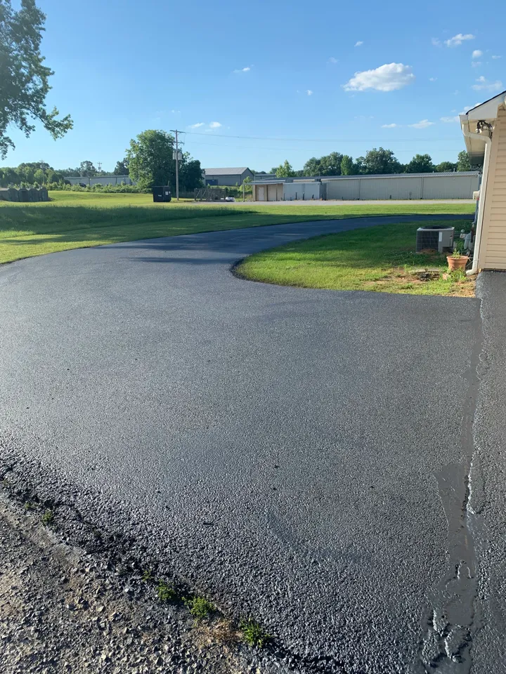 Freshly sealcoated residential asphalt driveway in North Mississippi